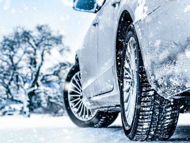 Winterreifen: Ein Auto steht auf einem schneebedecktem Untergrund.